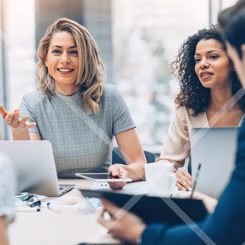 Two women colleagues having a discussion around a table