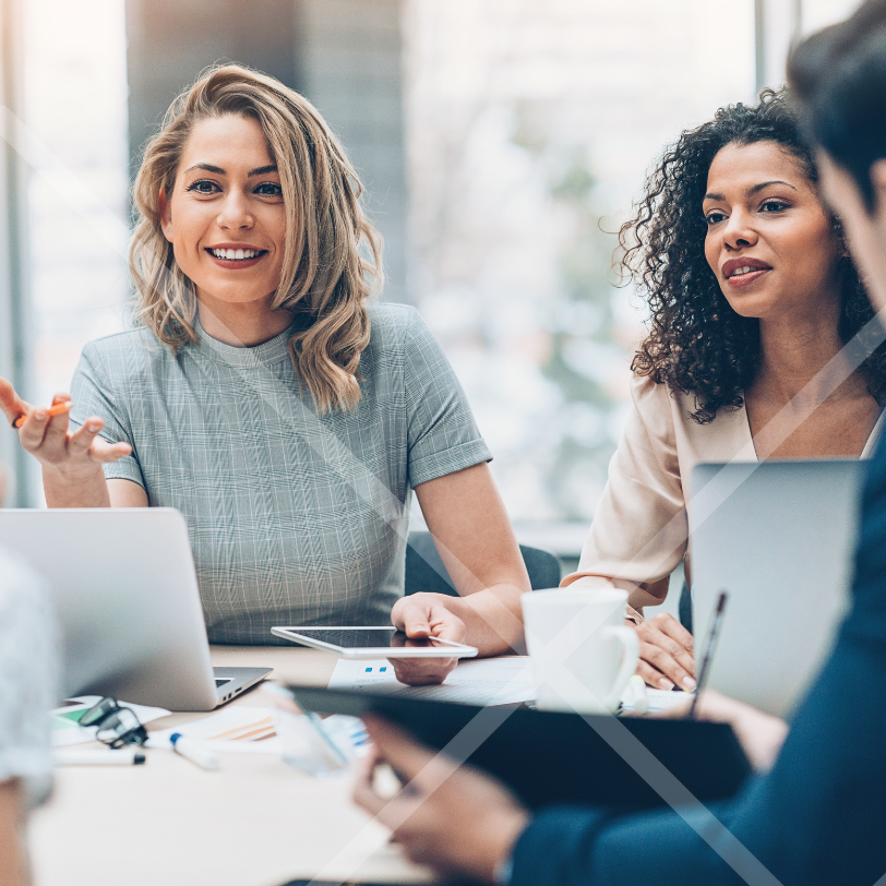 Two women colleagues having a discussion around a table