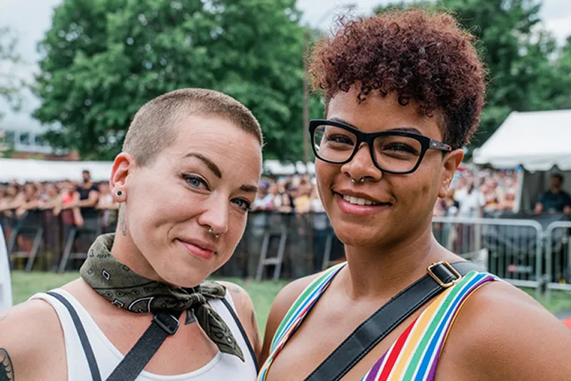 Two attendees smiling at Indy Pride festival, where Billfold POS powers seamless cashless payments.