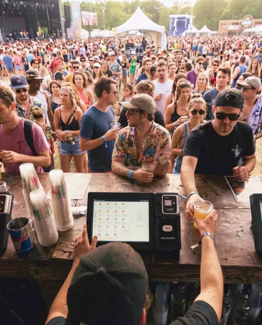 Guest paying with an RFID wristband at an event