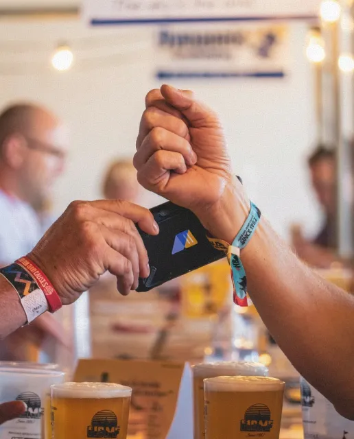 Guest paying with an RFID wristband at an event