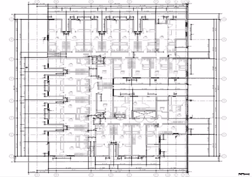 Architectural floor plan of a building with multiple rooms and detailed measurements.