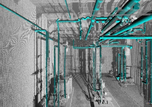 Complex network of turquoise pipes and industrial structures viewed from above inside a facility.