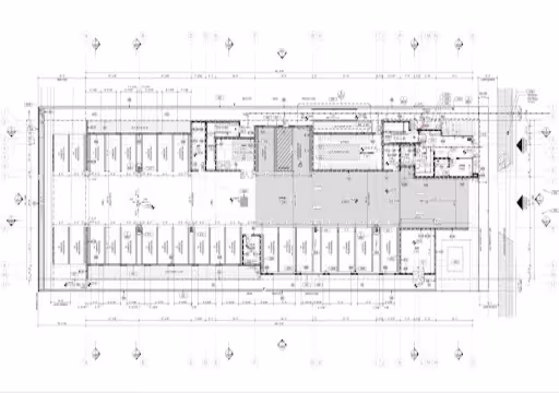 Architectural floor plan with marked rooms, dimensions, and layout details in grayscale.
