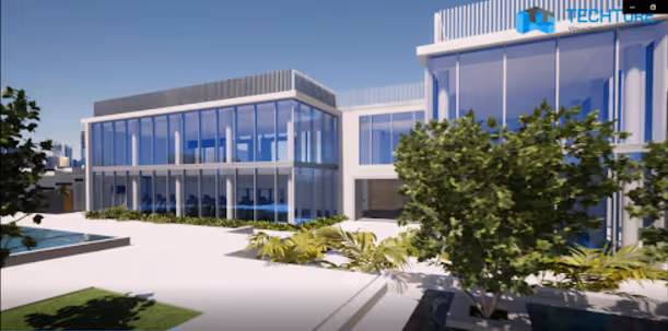 Modern two-story building with large glass windows and a landscaped green courtyard.