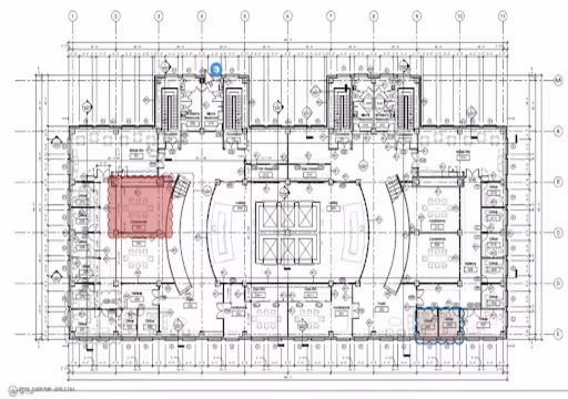 Architectural floor plan with highlighted red and blue sections marking specific areas within the building layout.