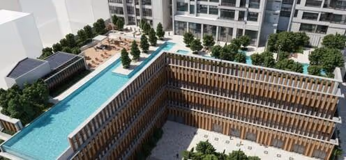 Aerial view of a modern courtyard with a rectangular pool, trees, seating, and multi-story buildings.