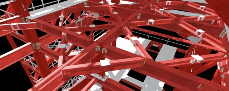 Close-up of intersecting red steel beams with metal plates and bolts in a structural framework.