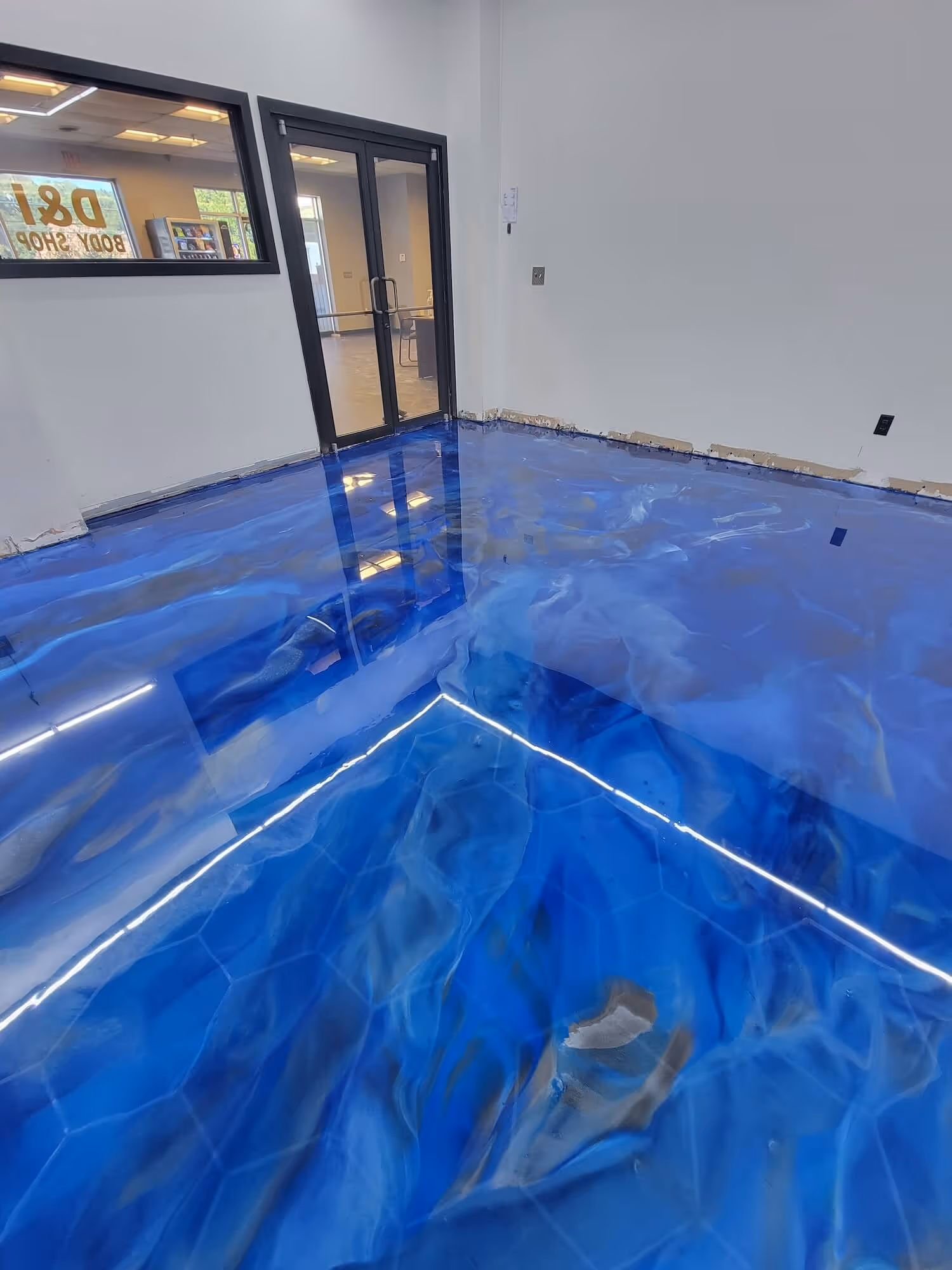 Blue metallic epoxy floor at a Duluth, GA commercial entrance