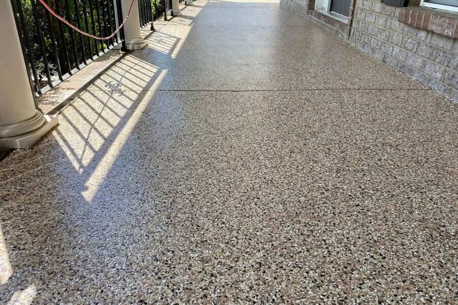 Smooth quartz epoxy floor coating on a porch with brick wall in atlanta, ga.