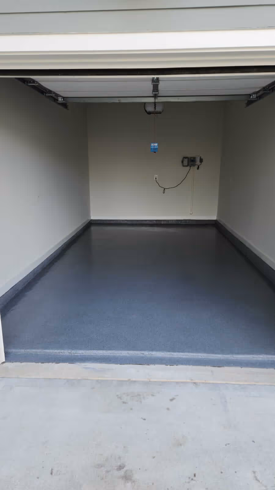 Freshly coated gray epoxy garage floor by ACC Facility Services in Alpharetta, GA