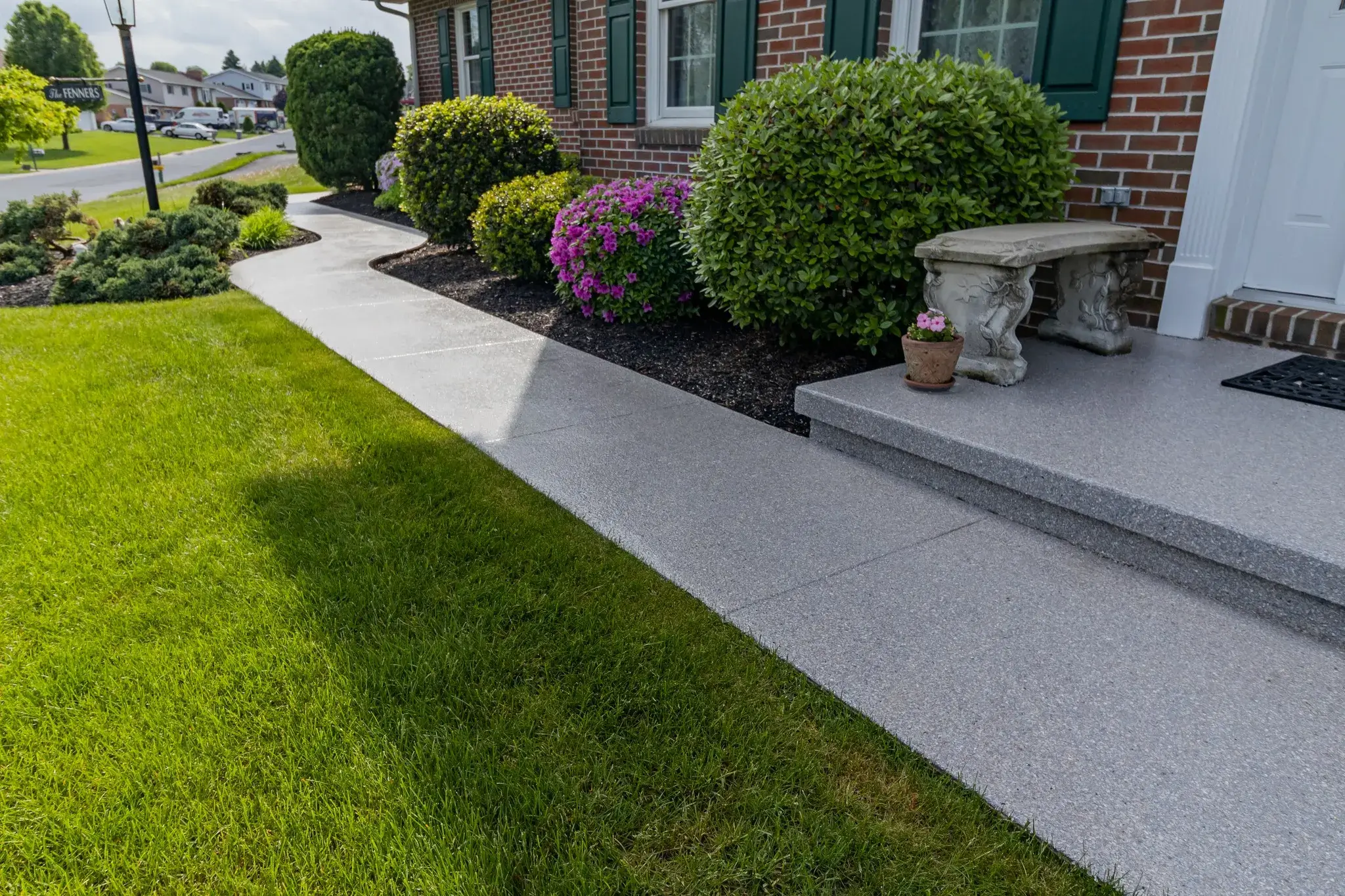 Curved gray concrete in quartz epoxy walkway and porch in atlanta ga.