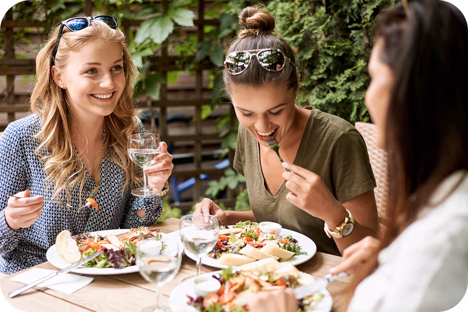 Group of restaurant guests enjoying a meal together, representing targeted audience segments for personalized marketing campaigns.