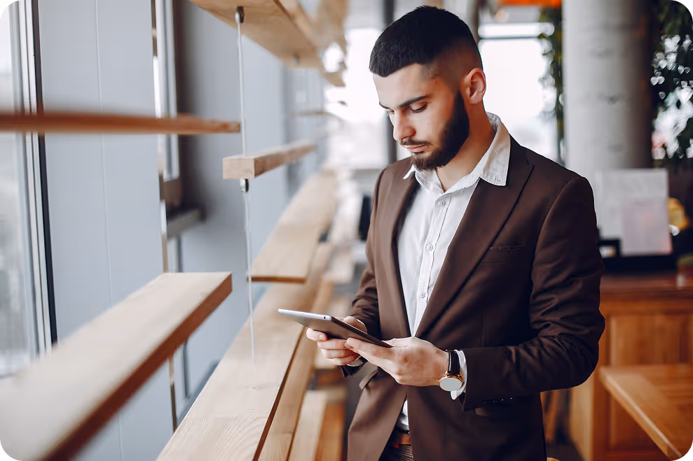 Restaurant manager reviewing reservation details on his phone, ensuring accurate fees and no manual adjustments.
