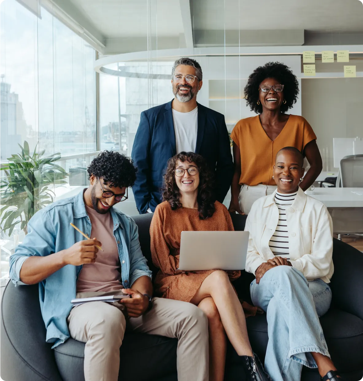 smiling business people sitting on a couch in an office