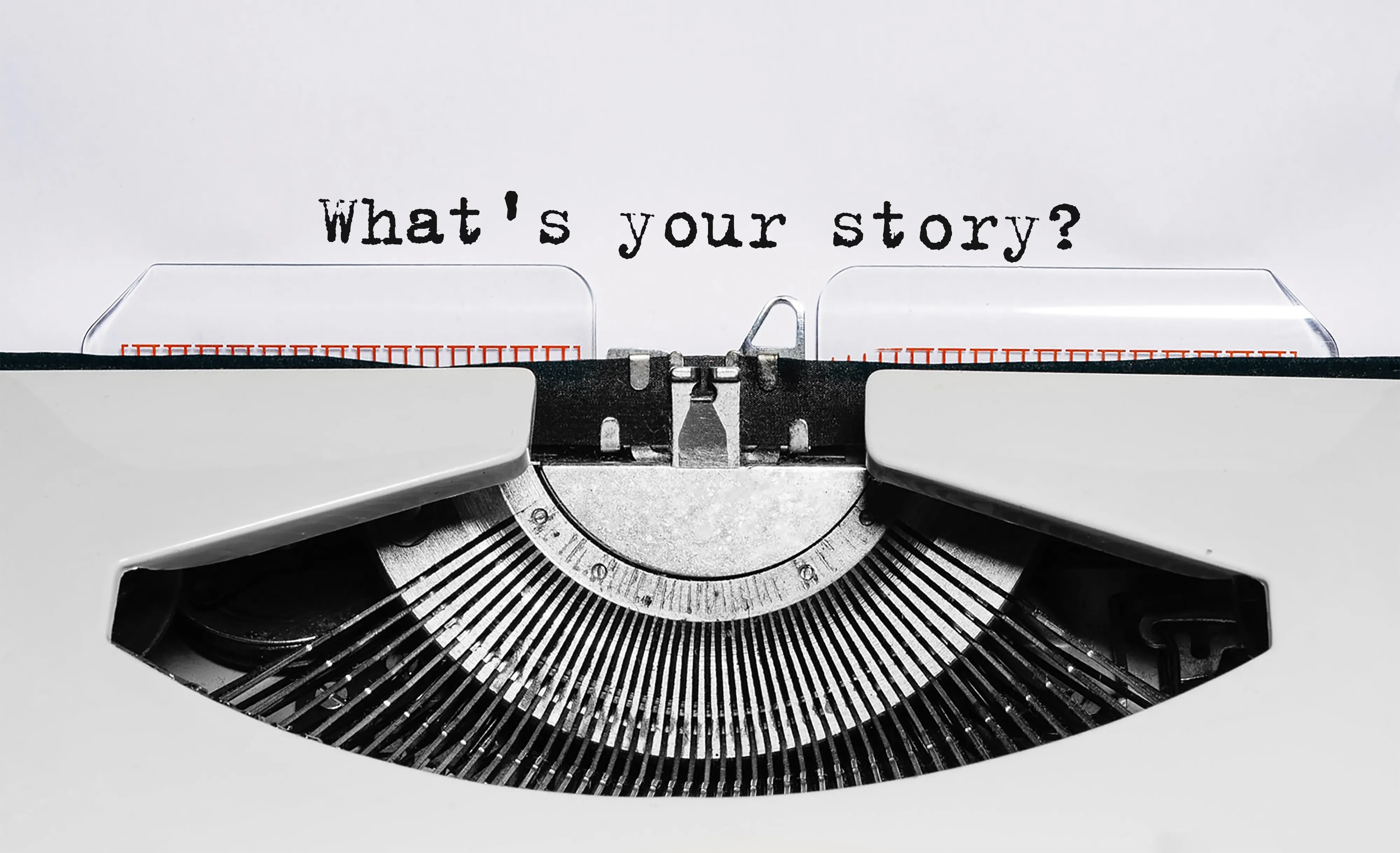 typewriter showing text "what's your story"