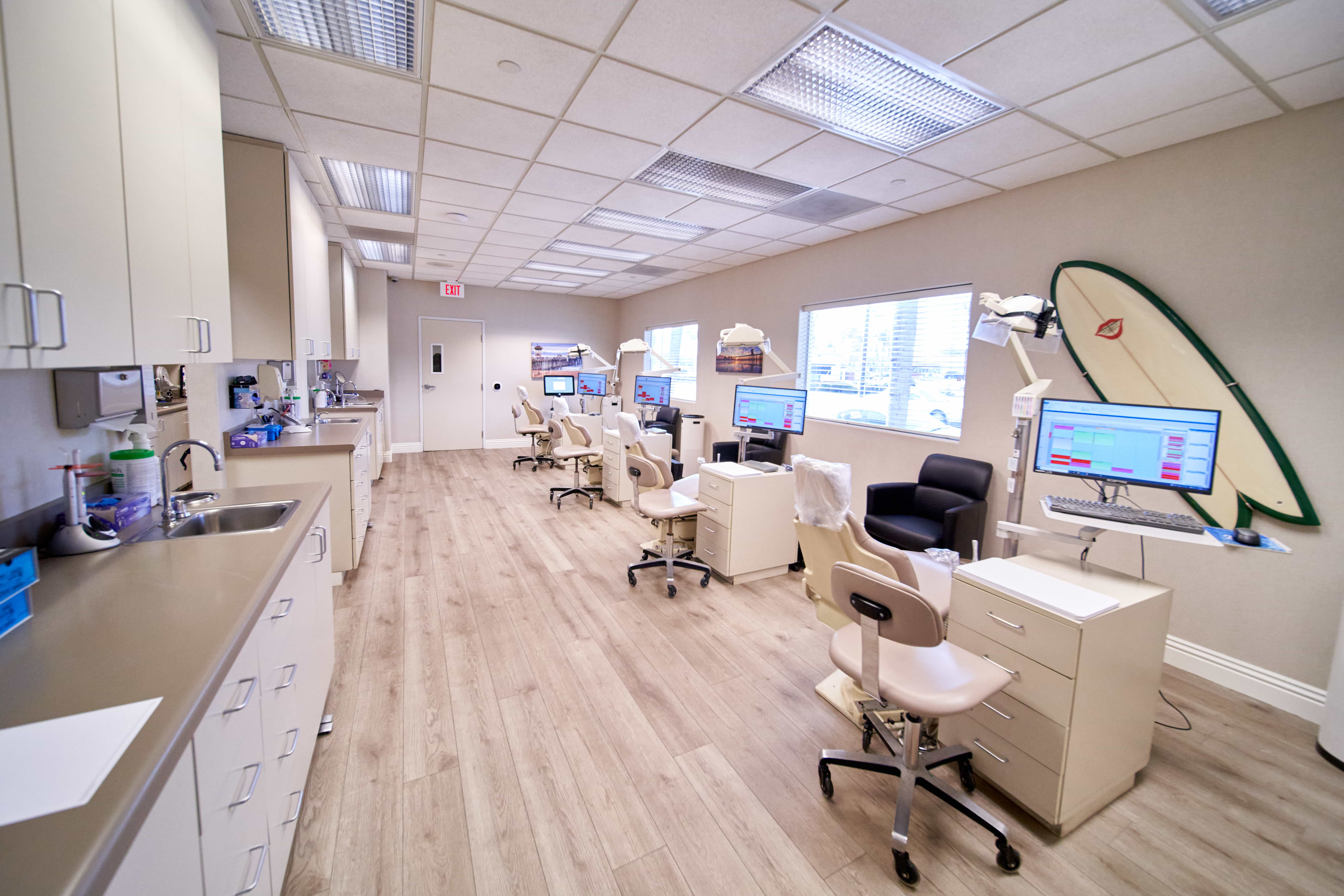 Open treatment area with surfboard decor at Surf City Orthodontics in Huntington Beach