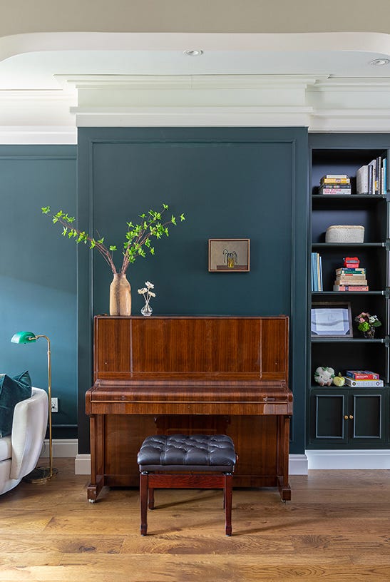 interior space featuring a stacked bookshelf piano and seating area
