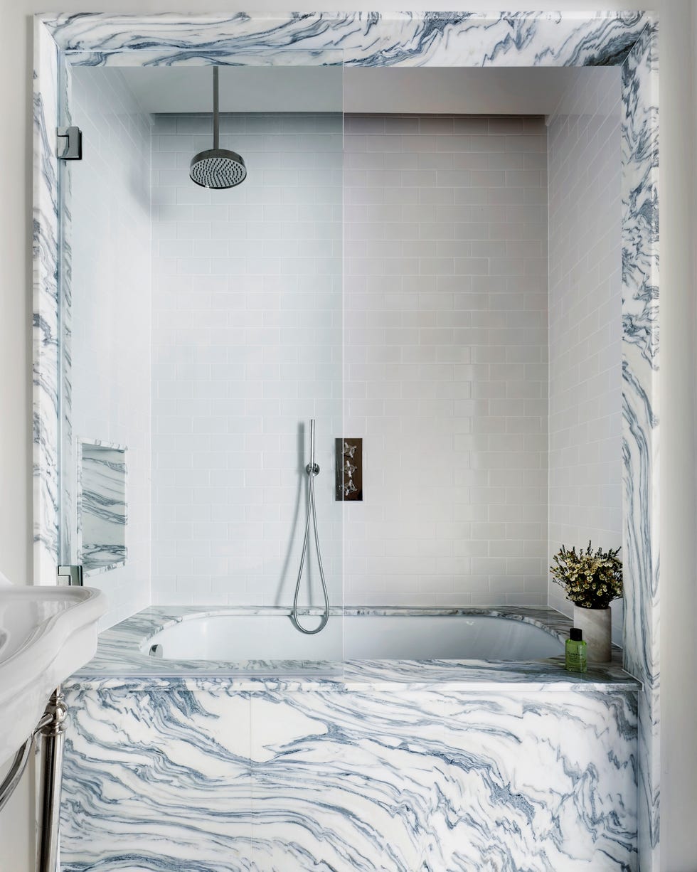 built in marble bath built into an alcove with a marble surround