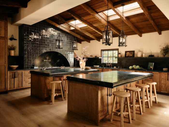 The kitchen became a showcase for attention to detail with a custom hood, custom tile and brass fixtures.