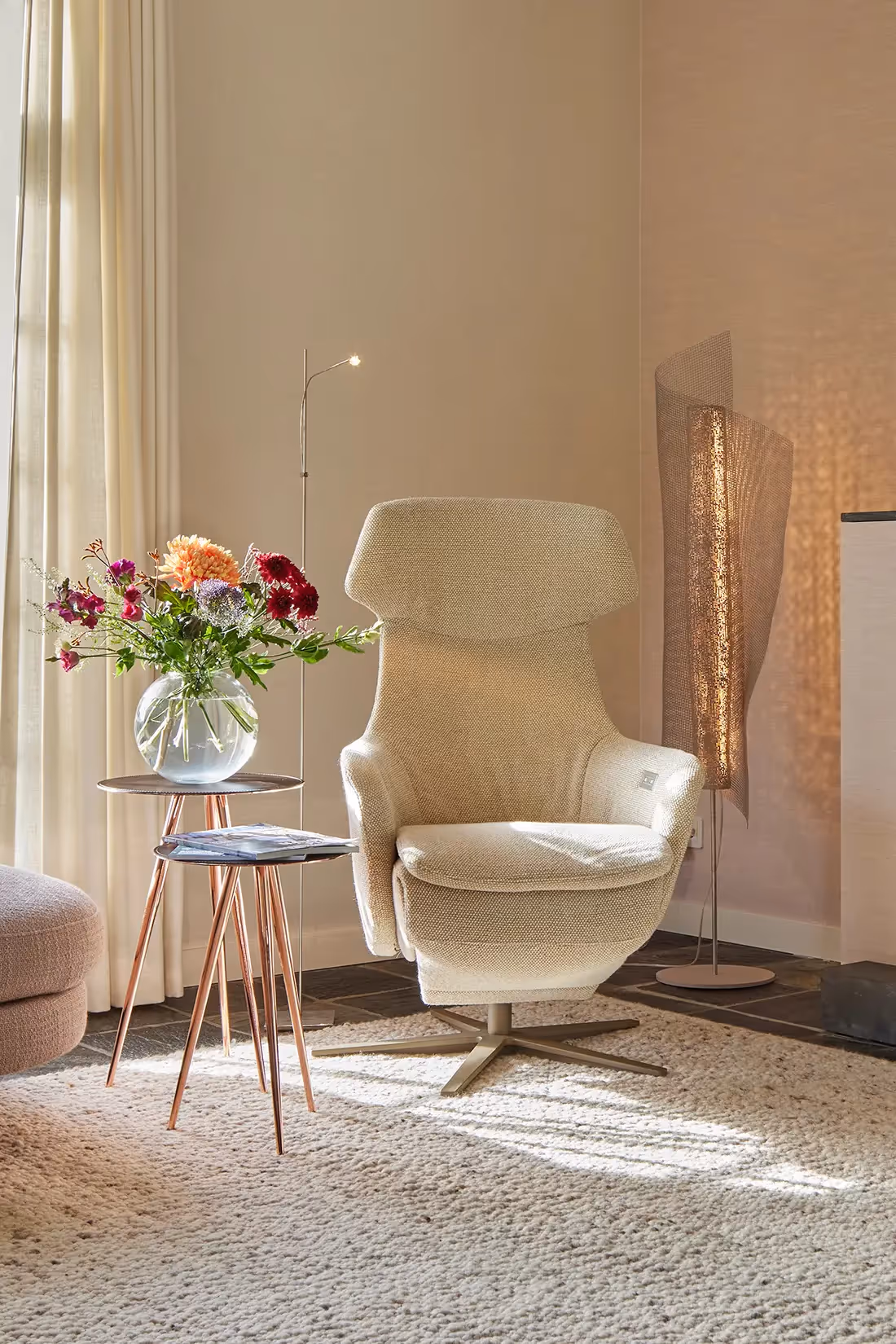 Fauteuil omringd door sfeerverlichting en leeslamp.