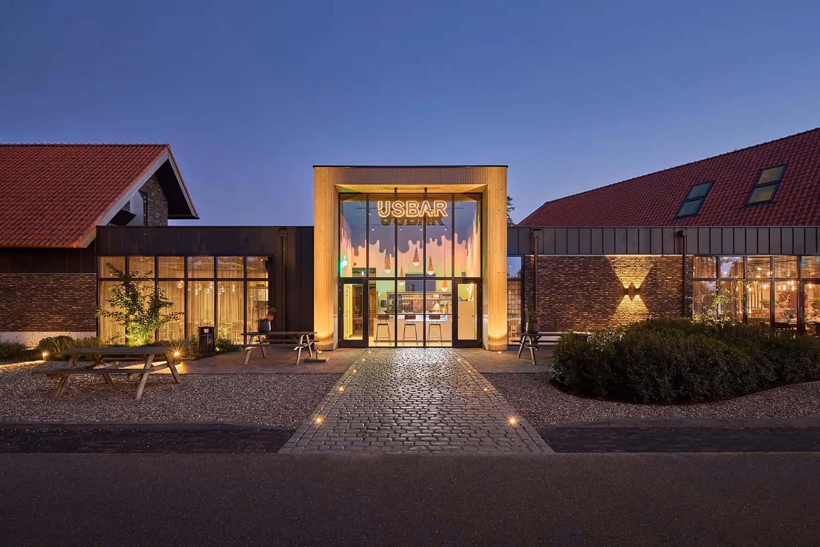 Grondspots bij entreegevel van een ijsalon.