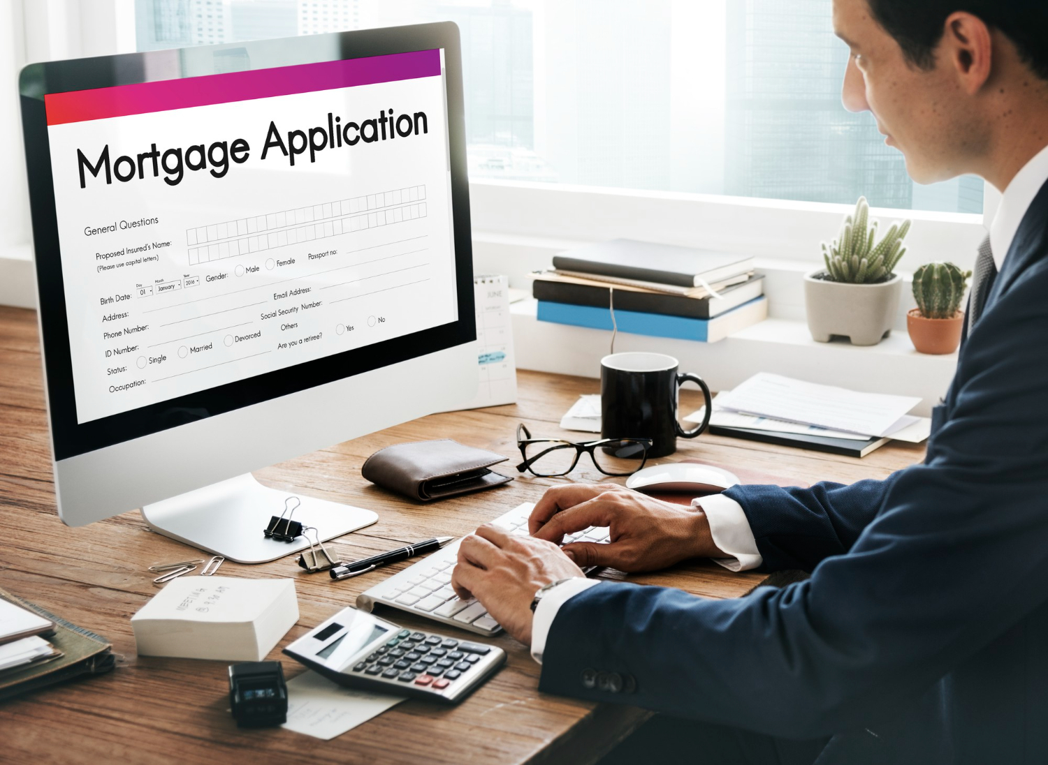 man filling out mortgage application in computer