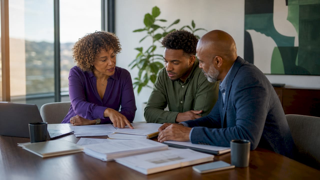 Hands sorting subcontractor mortgage papers