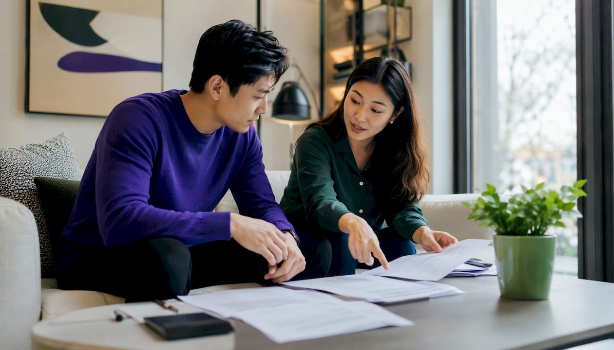 Couple reviewing foreign income paperwork at home
