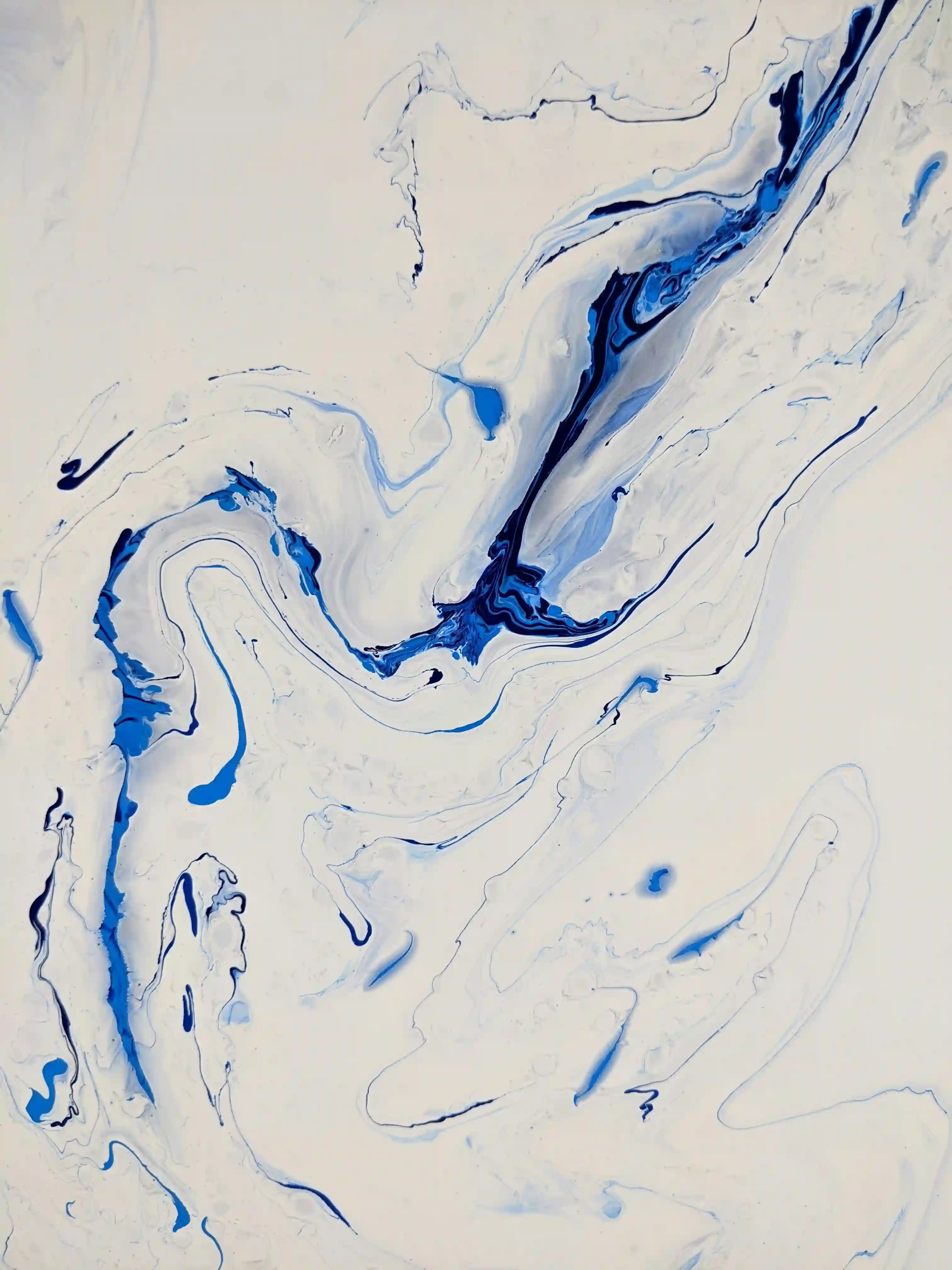 Abstract fluid art with swirling blue and white paint creating organic shapes and flowing patterns.