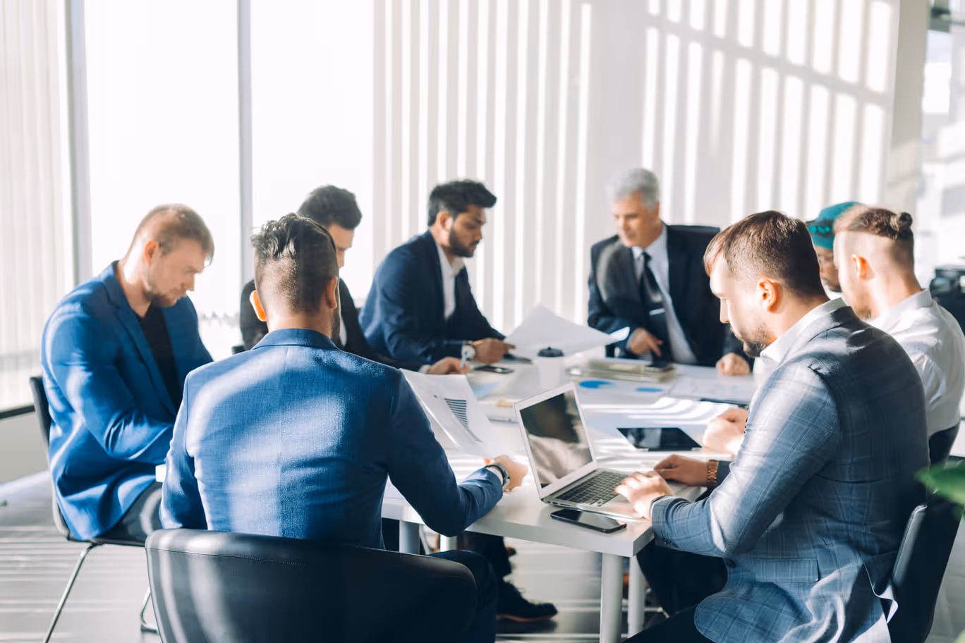 Business team consulting together during a meeting around a table.