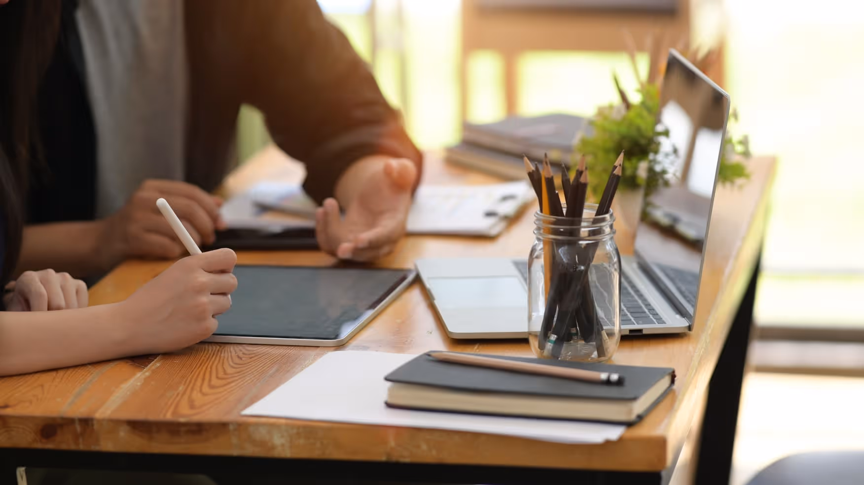 Male and female AI spesialists in AI development solutions using digital tablet in the office
