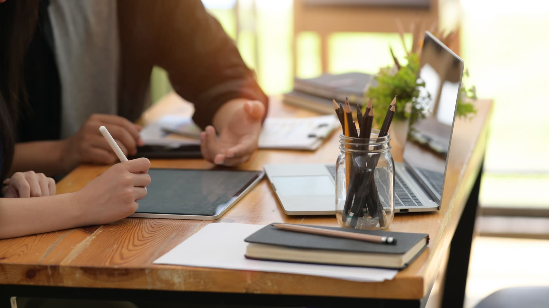 Male and female AI spesialists in AI development solutions using digital tablet in the office