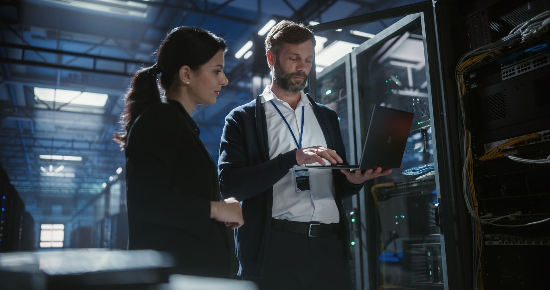 Accounting and IT professionals reviewing secure infrastructure in a data center, representing AI data security, access control, and protection of sensitive client financial data.