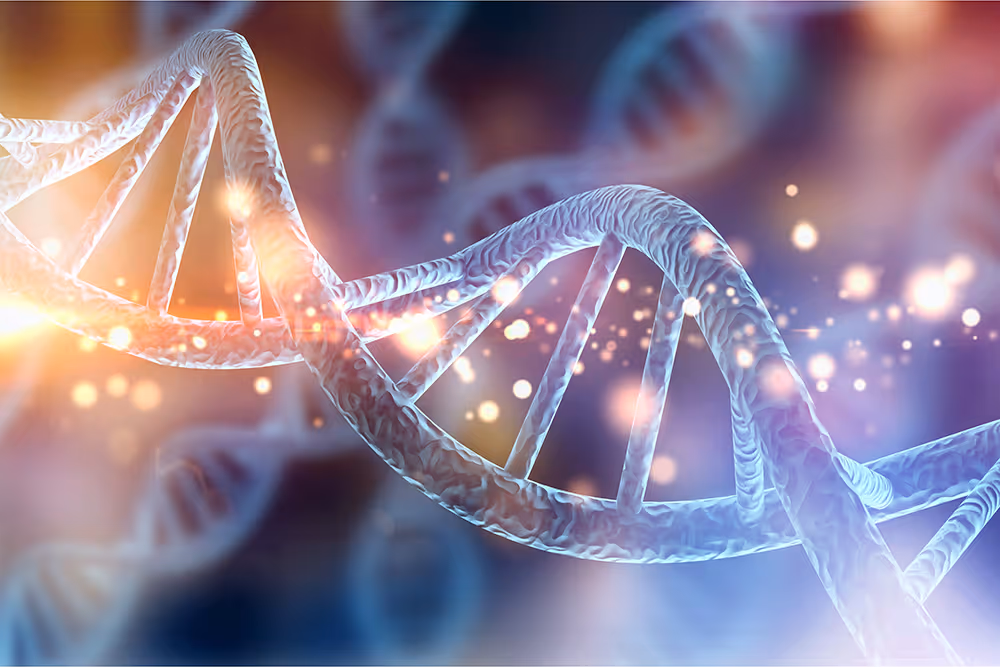 Close-up of a glowing 3D DNA double helix with light particles and a blurred background.