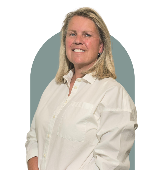 Headshot of Tracey Otaguro from waist up smiling in a business casual top. 