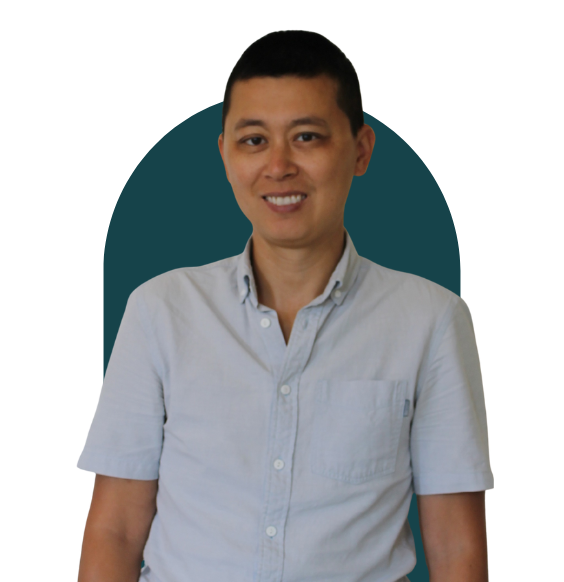Headshot of Ming Ma from waist up smiling in a business casual top. 