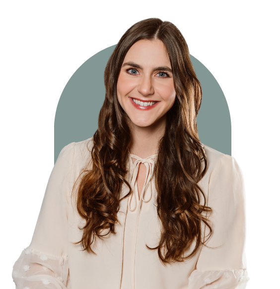 Jessica Kristy from the waist up smiling in a pink coloured t-shirt.