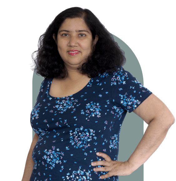 Headshot of Meghana Kotwal from waist up smiling in a business casual top.