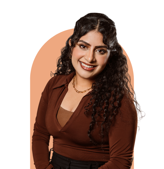 Headshot of Taninder Atwal from waist up smiling in a business casual top.