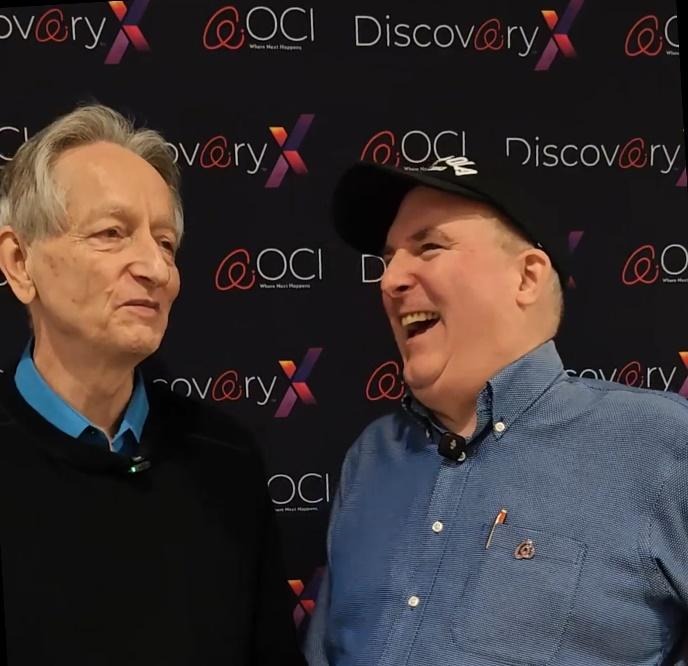 Two men standing in front of a wall with textAI-generated content may be incorrect.