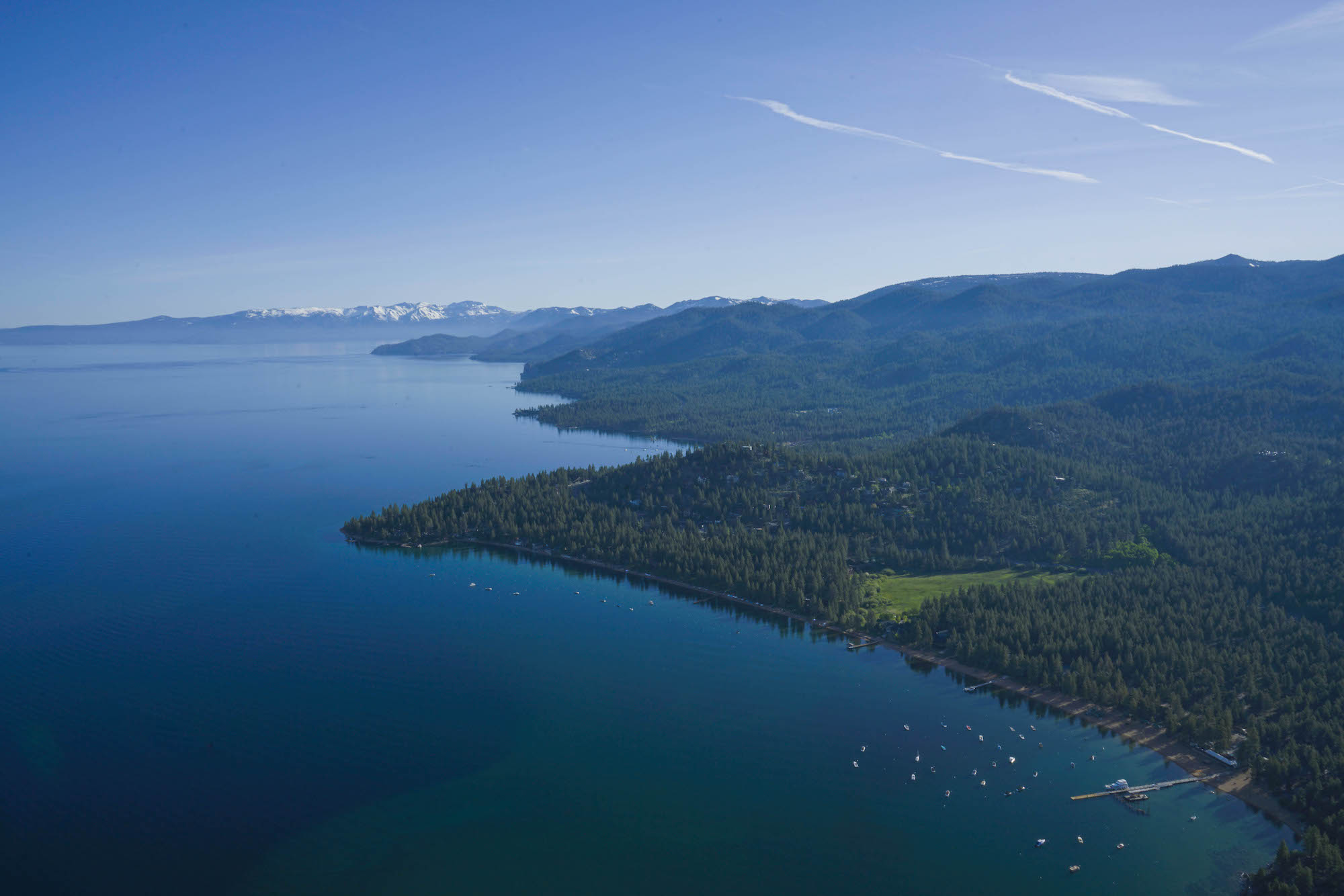 Aerial view of Lake Tahoe's forested shoreline and marina