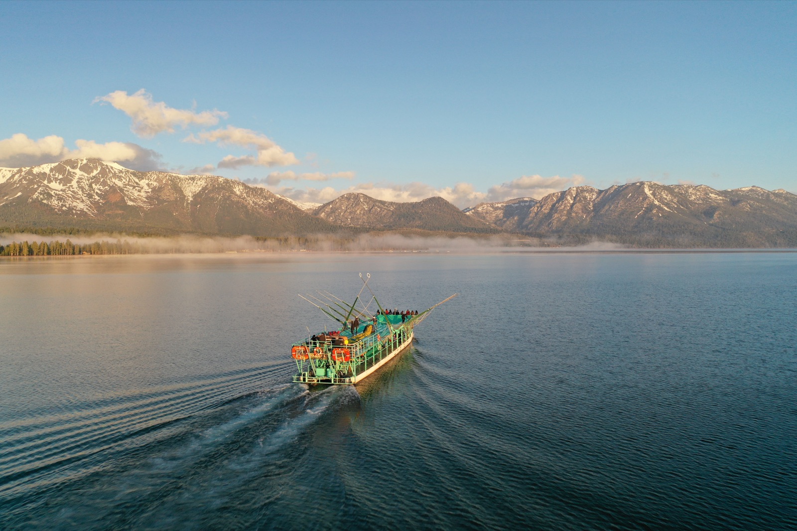 The Tahoe Flyer launch boat crossing Lake Tahoe at dawn, seen from above