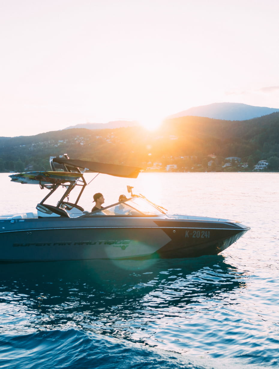 A powerboat on the water at sunset
