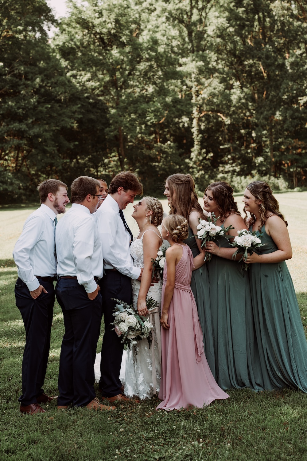 Monica & Caleb enjoy a moment with their bridal party after the wedding.  
