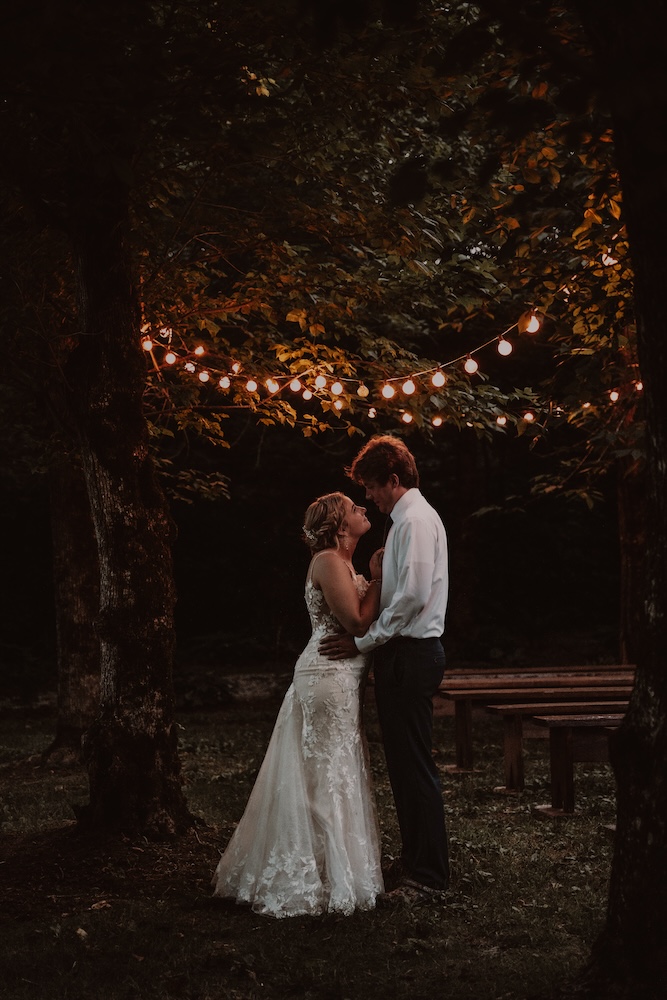 Evening photo under the string light in the woods at The Barn at Cedar Grove in south central KY