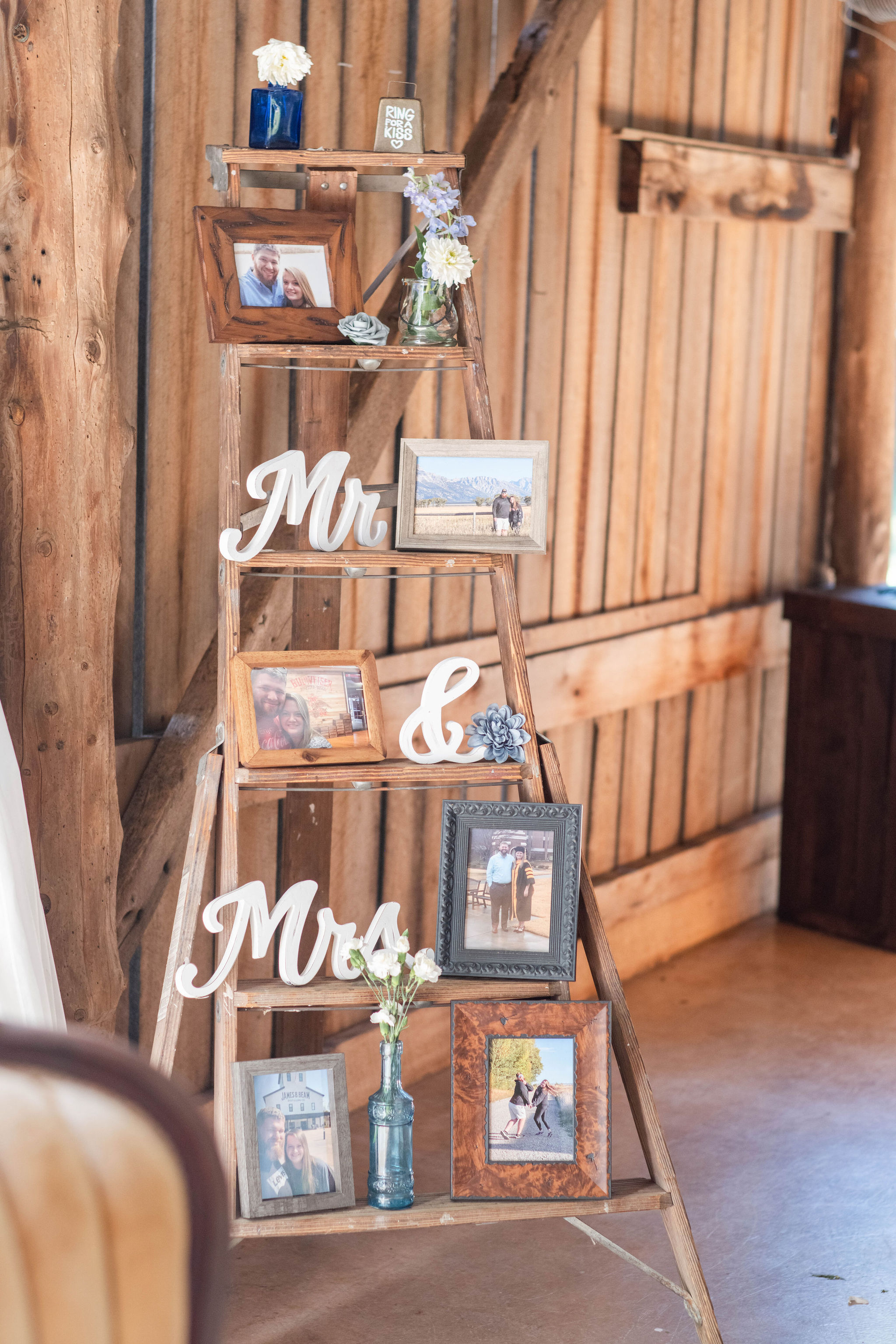 Our antique ladder serves as a great photo display at The Barn at Cedar Grove.