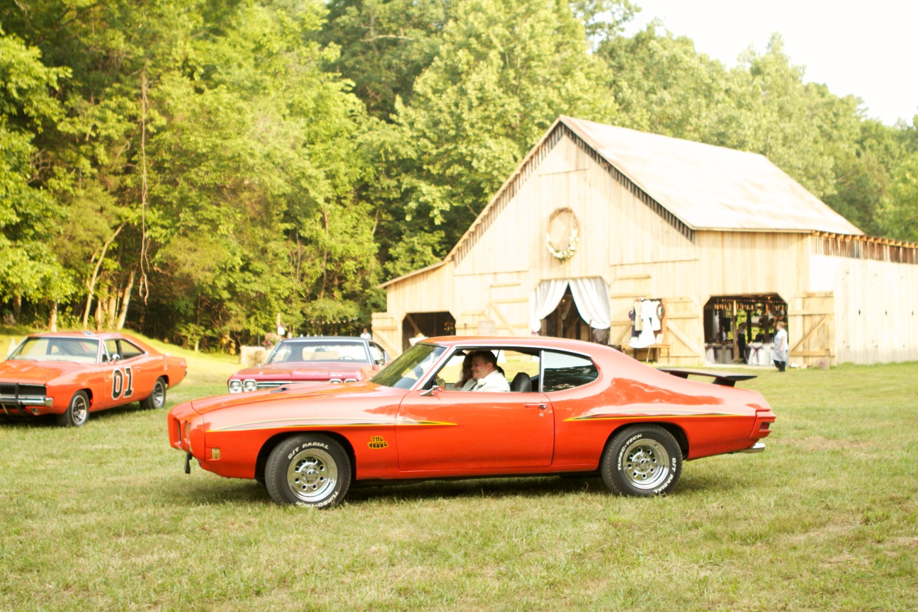 Bridal party arrives in antique cars