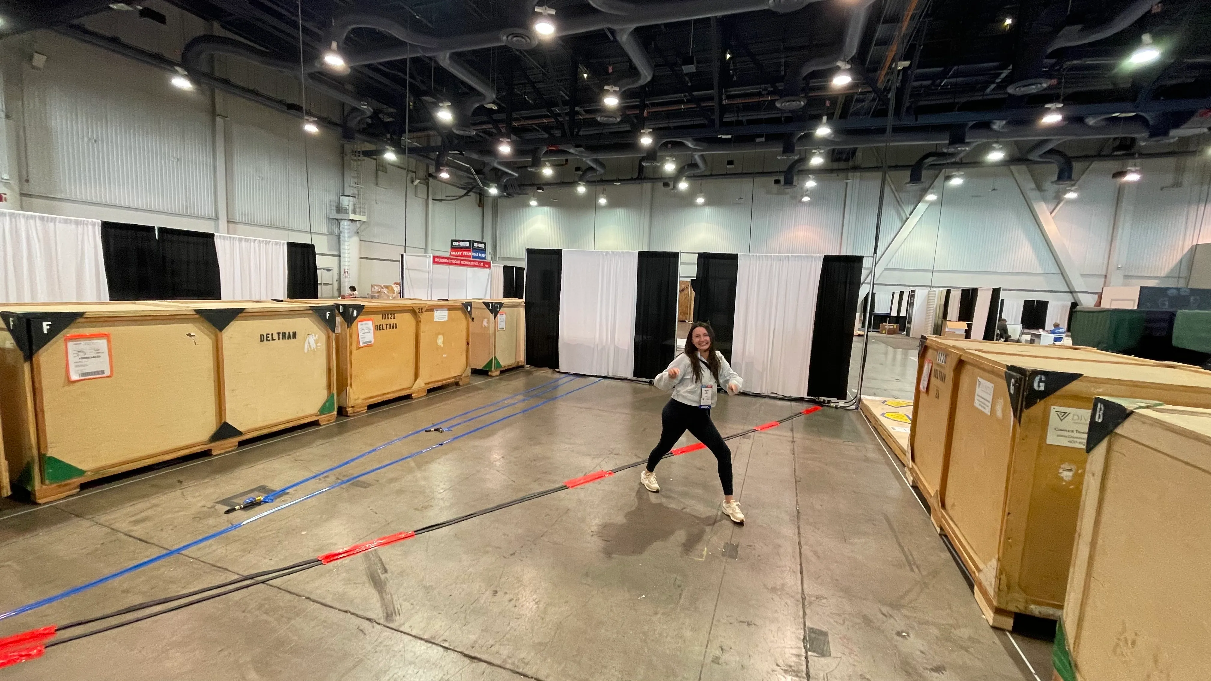 Brittaney at the SEMA automotive trade show in the Battery Tender booth space before the booth was taken out of the crates she is surrounded by.