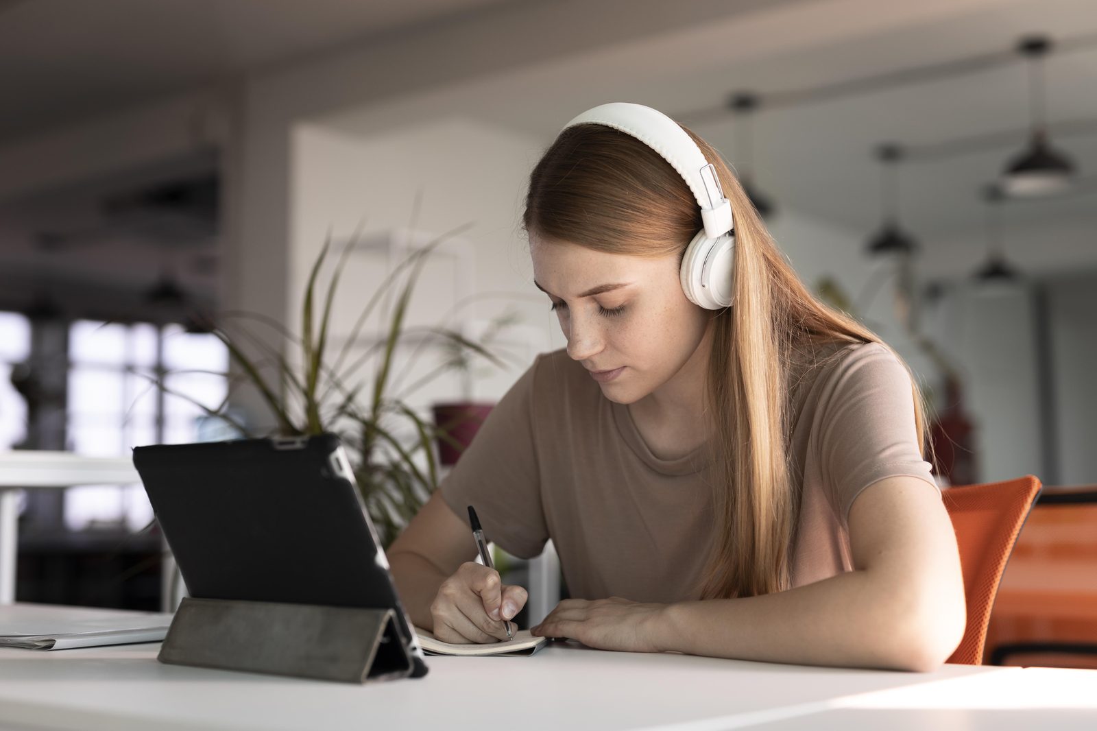 Parent taking notes while preparing for a meeting